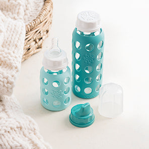 Lifefactory narrow neck glass baby bottles in 4 ounce and 9 ounce with assortment of caps.