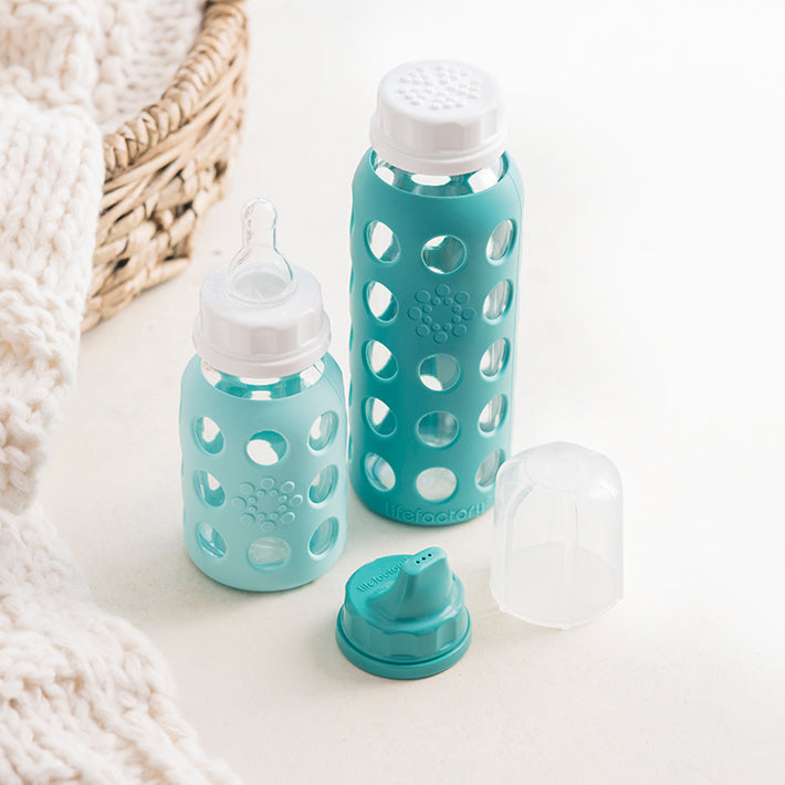 Lifefactory narrow neck glass baby bottles in 4 ounce and 9 ounce with assortment of caps.