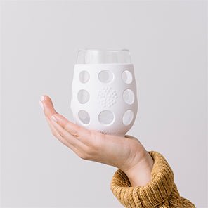 Hand holding a Lifefactory stemless wine glass.