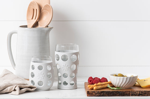 Lifefactory stemless wine glass and beer glass on a kitchen counter.