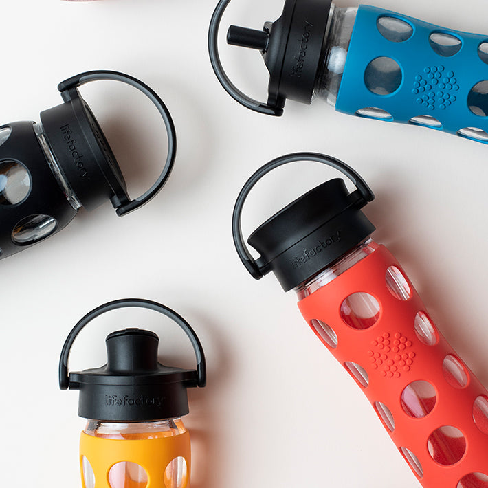 22oz Glass Water Bottles with assortment of caps.
