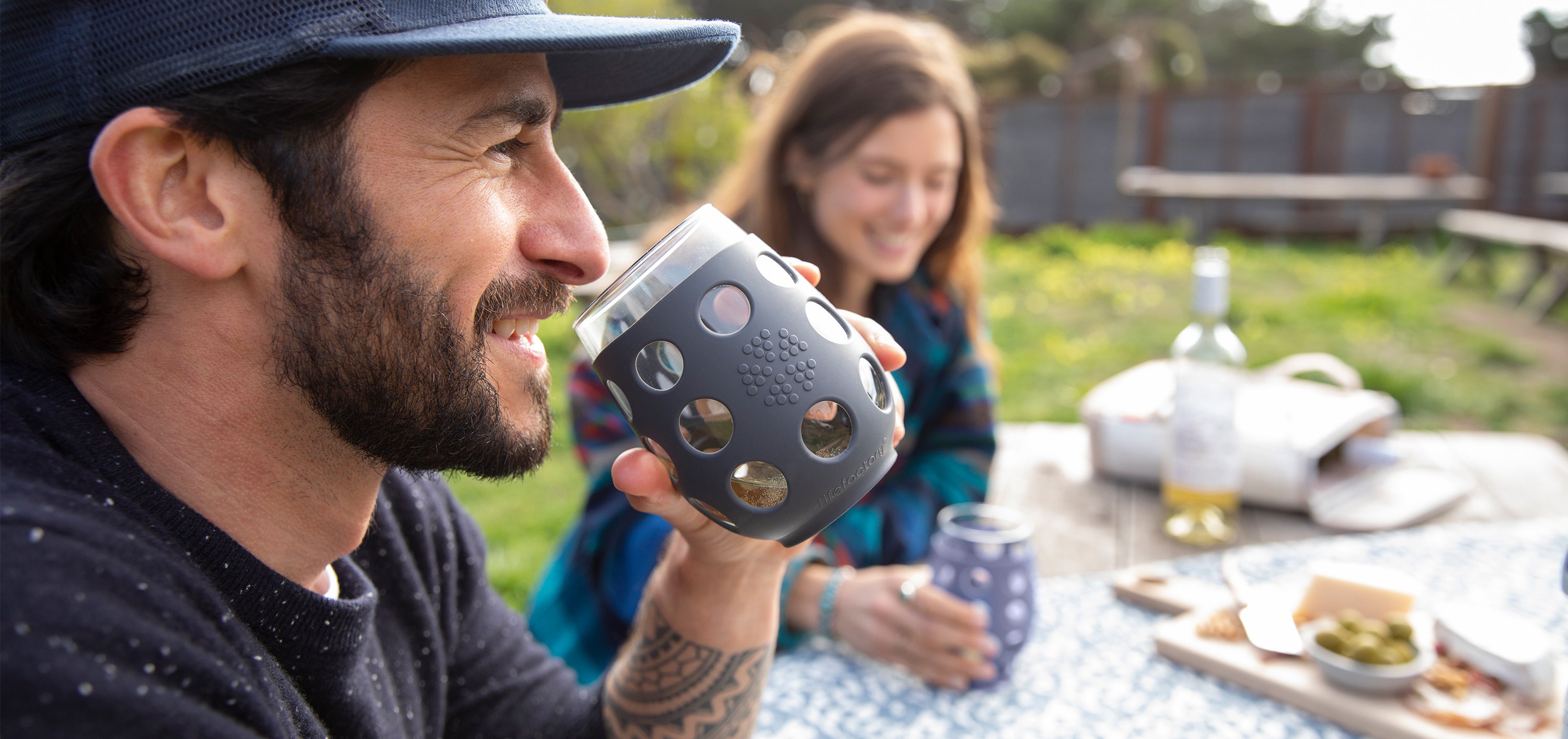 People at a picnic, drinking from Lifefactory stemless wine glasses.