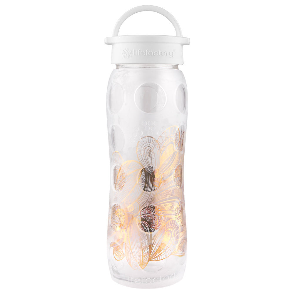 http://lifefactory.com/cdn/shop/products/22oz-glass-water-bottle-with-silicone-sleeve-and-classic-cap-fused-gold-optic-white-floral-1.jpg?v=1695321496