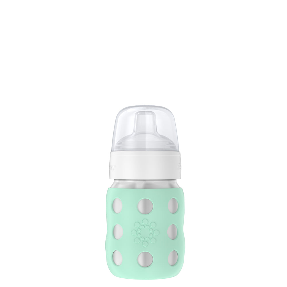 A Lifefactory 8oz Stainless Steel Baby Bottle with a green sippy spout.